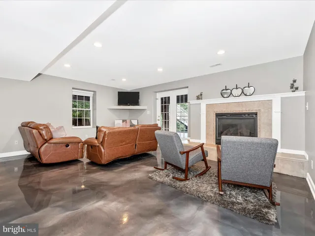 a view of a patio with table and chairs under an umbrella with wooden floor