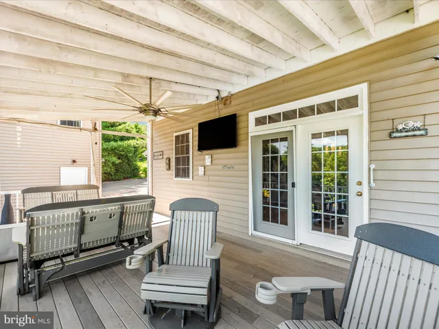 a view of a roof deck with chair and wooden floor