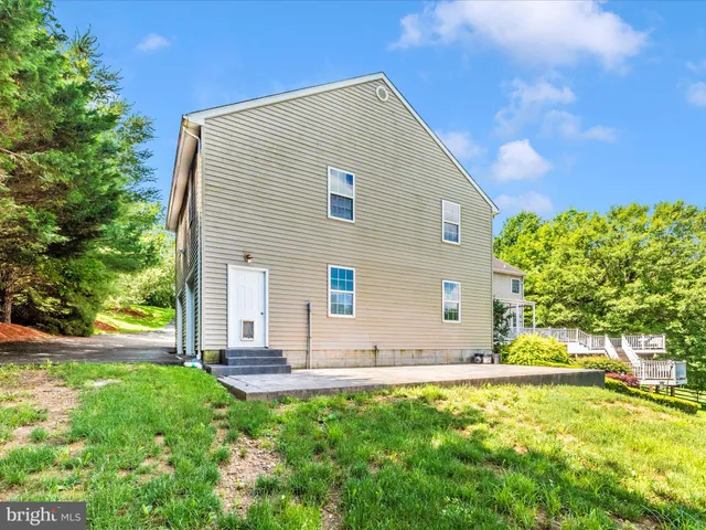 a aerial view of a house with yard and green space