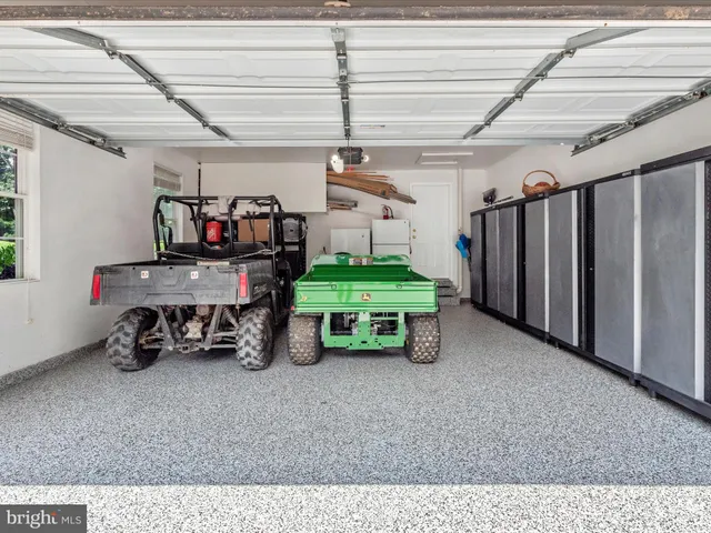 an aerial view of a house with a yard and large tree