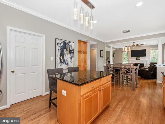 a large kitchen with lots of counter space a sink and furniture