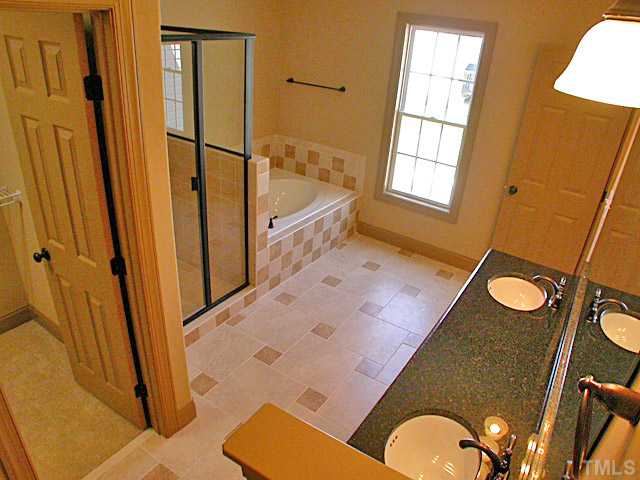 4626 Pat Reed Road Raleigh, NC 27616 - Photo 13 of 20 a bathroom with a sink a mirror and a shower
