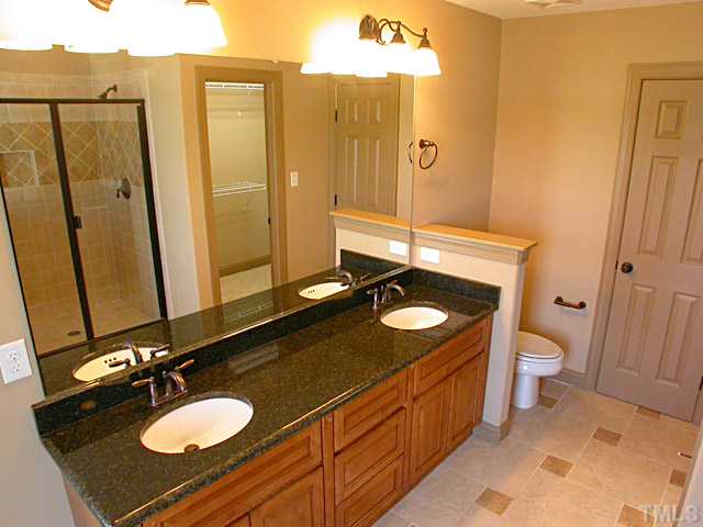 4626 Pat Reed Road Raleigh, NC 27616 - Photo 14 of 20 a bathroom with a granite countertop sink and a mirror