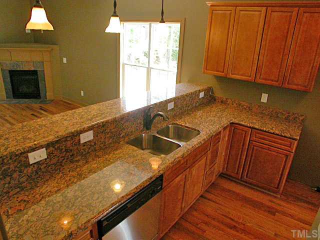 4626 Pat Reed Road Raleigh, NC 27616 - Photo 2 of 20 a kitchen with stainless steel appliances granite countertop a sink a stove counter space and cabinets