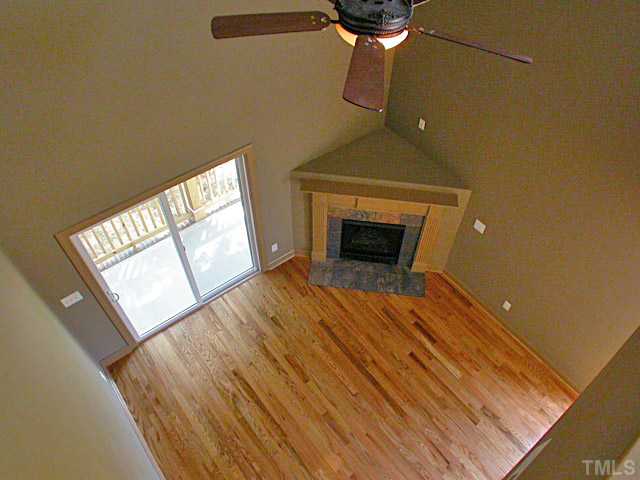 4626 Pat Reed Road Raleigh, NC 27616 - Photo 8 of 20 a view of empty room with wooden floor and fireplace