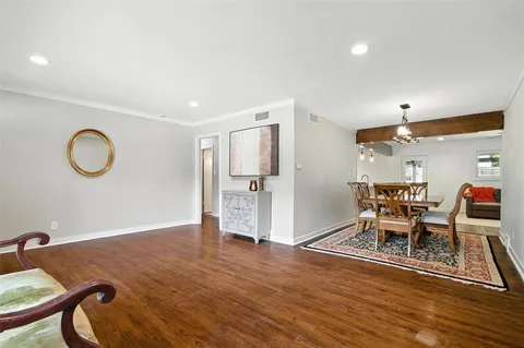 a dining room with furniture and wooden floor