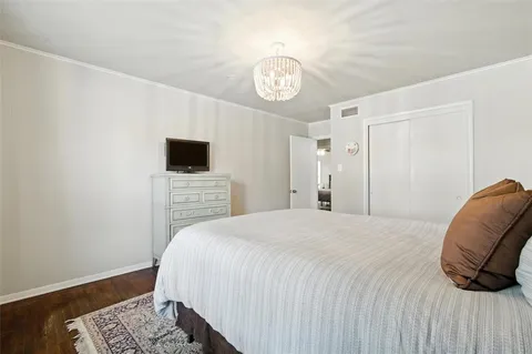 a bedroom with a bed a tv and a window