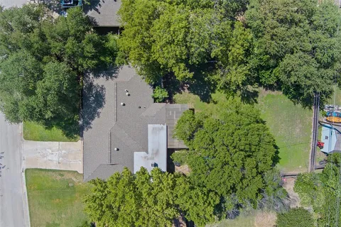 an aerial view of a house with a yard and garden