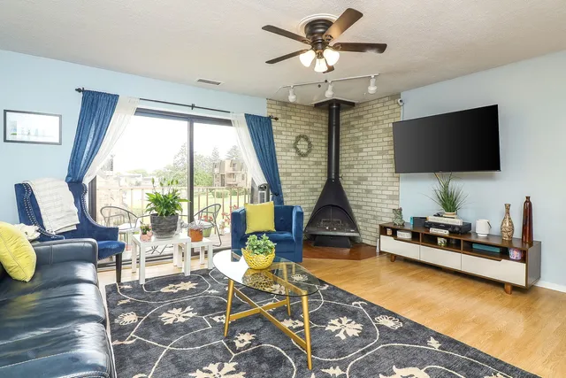 a living room with patio furniture and a flat screen tv