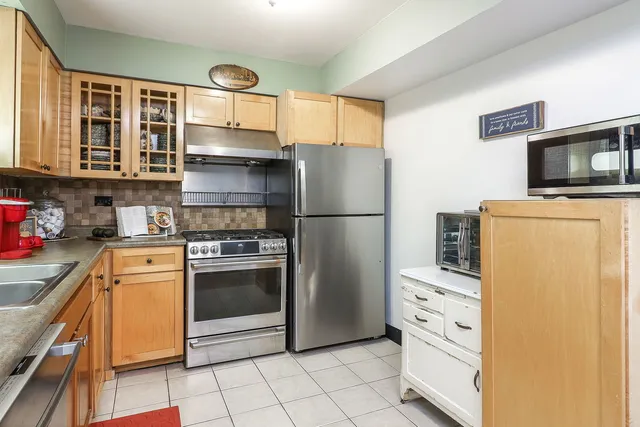 a kitchen with stainless steel appliances a refrigerator stove and microwave