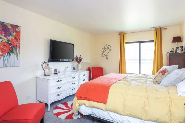 a bedroom with a bed and a flat screen tv