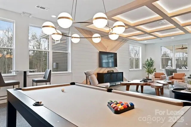 a very nice looking dining room with a large kitchen island furniture and a chandelier