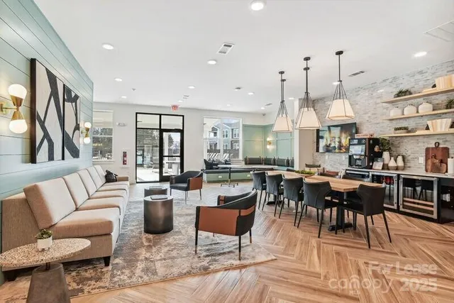 a living room with lots of furniture and a large window