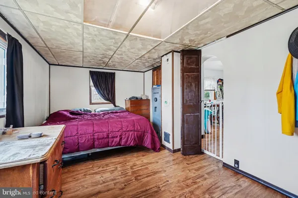a bedroom with a bed and a mirror