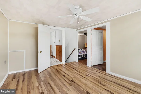 a view of a room with wooden floor staircase and hallway