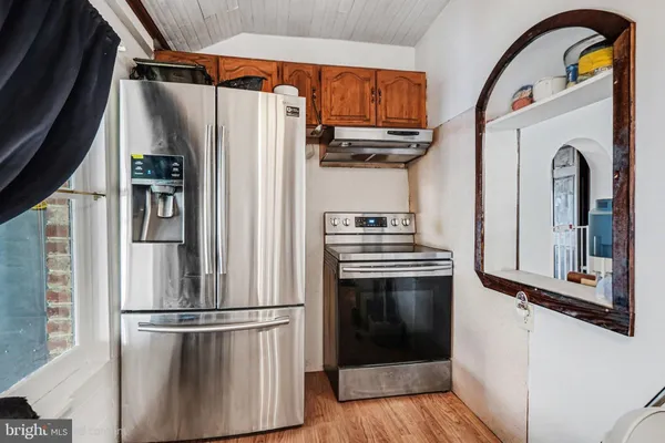 a kitchen with stainless steel appliances granite countertop a refrigerator and a stove
