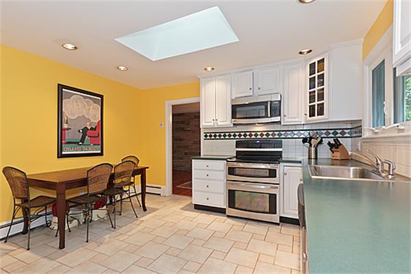 2 Wickham Road Winchester, MA 01890 - Photo 10 of 16 a kitchen with stainless steel appliances a stove a sink a microwave and a refrigerator