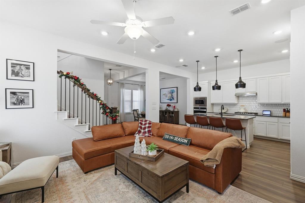 2331 Jack Rabbit Way Northlake, TX 76247 - Photo 12 of 39 a living room with furniture kitchen view and a wooden floor