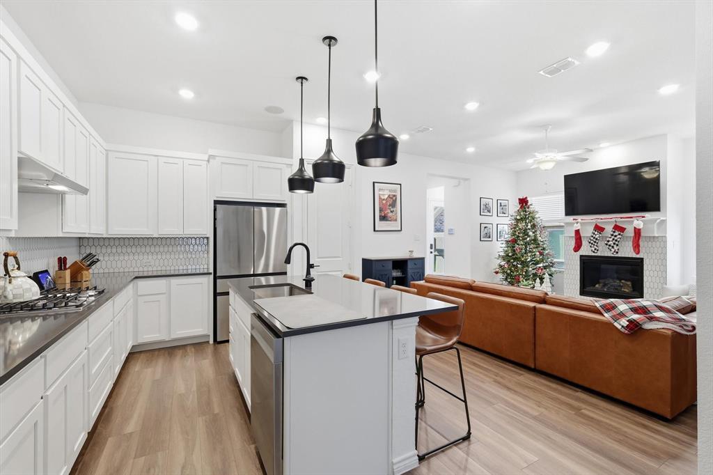 2331 Jack Rabbit Way Northlake, TX 76247 - Photo 15 of 38 a kitchen with a sink a counter top space a stainless steel appliances and cabinets