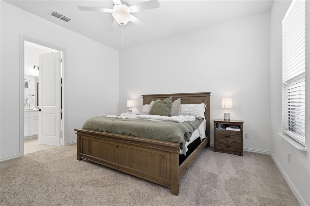 2331 Jack Rabbit Way Northlake, TX 76247 - Photo 17 of 38 a bedroom with a bed and a chandelier