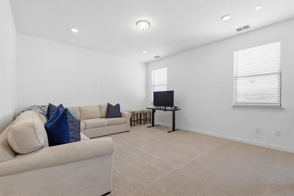 2331 Jack Rabbit Way Northlake, TX 76247 - Photo 20 of 38 a living room with furniture and a flat screen tv