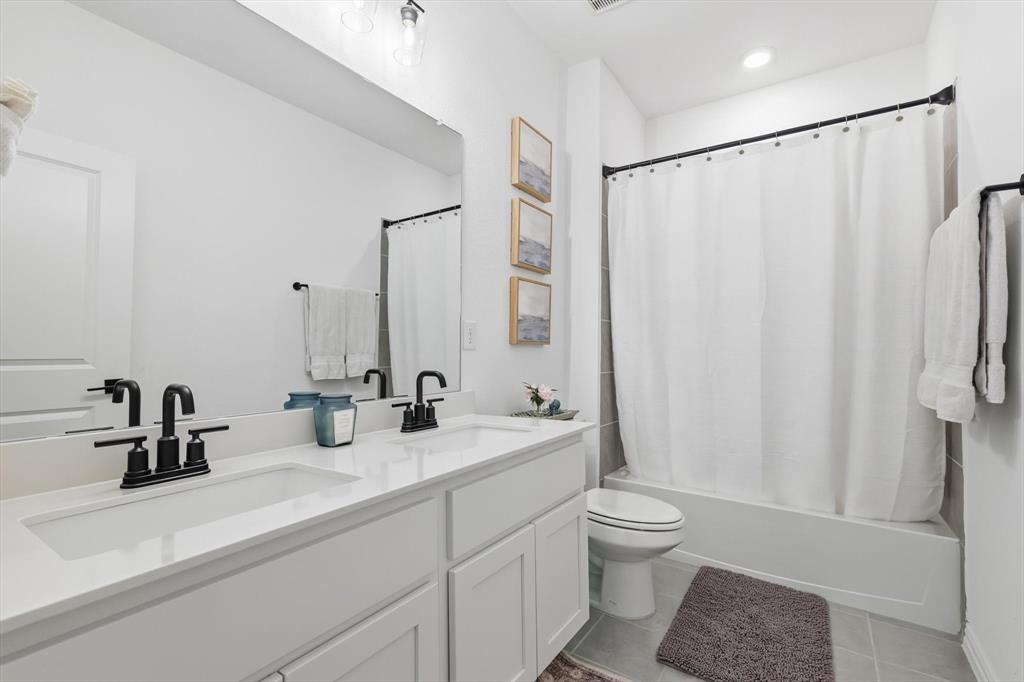 2331 Jack Rabbit Way Northlake, TX 76247 - Photo 24 of 38 a bathroom with a double vanity sink toilet and a mirror