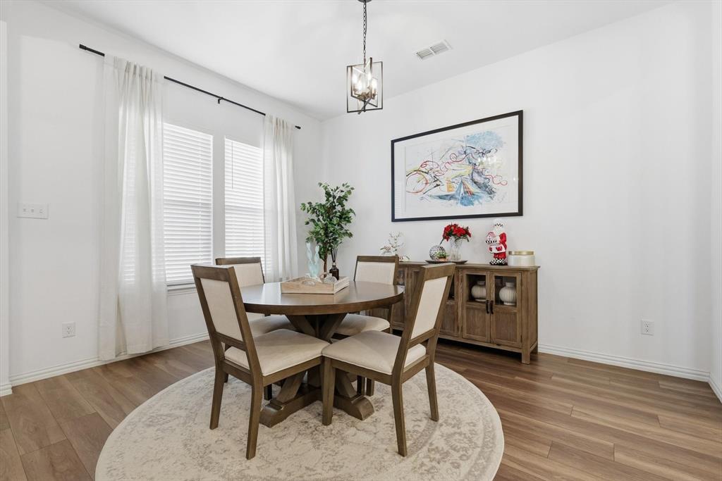 2331 Jack Rabbit Way Northlake, TX 76247 - Photo 6 of 39 a view of a dining room with furniture and wooden floor