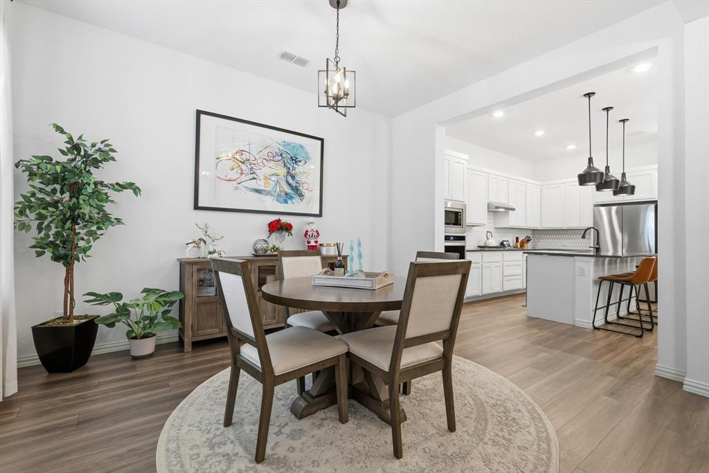 2331 Jack Rabbit Way Northlake, TX 76247 - Photo 7 of 39 a view of a dining room with furniture and wooden floor