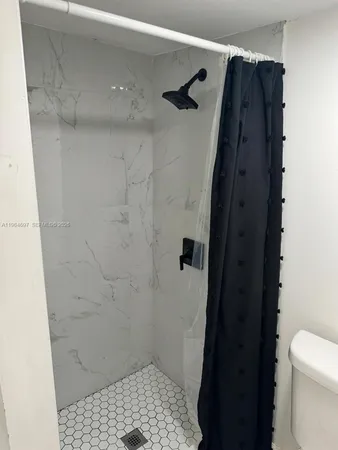 a bathroom with a shower and a toilet