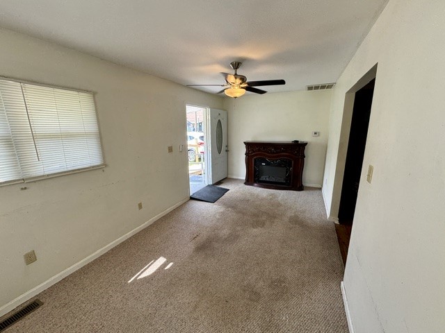 4744 Oxtoby Street Springfield, OH 45505 - Photo 6 of 19 This inviting living area features warm flooring and a classic fireplace, creating a cozy atmosphere.