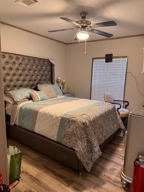 6218 Cr-4813 Pecan Gap, TX 75469 - Photo 17 of 30 Bedroom with ceiling fan, visible vents, wood finished floors, and ornamental molding