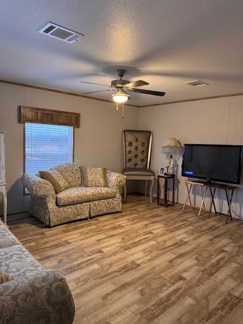 6218 Cr-4813 Pecan Gap, TX 75469 - Photo 20 of 30 Living room featuring ceiling fan, wood finished floors, visible vents, and a textured ceiling