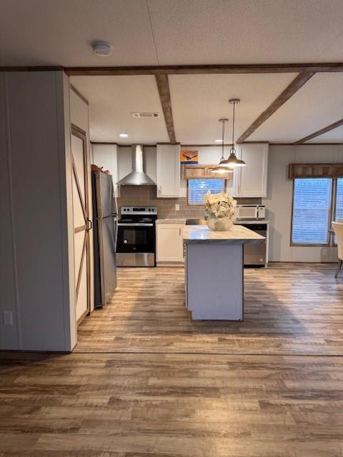 6218 Cr-4813 Pecan Gap, TX 75469 - Photo 27 of 30 Kitchen with wood finished floors, extractor fan, white cabinetry, fridge, and range
