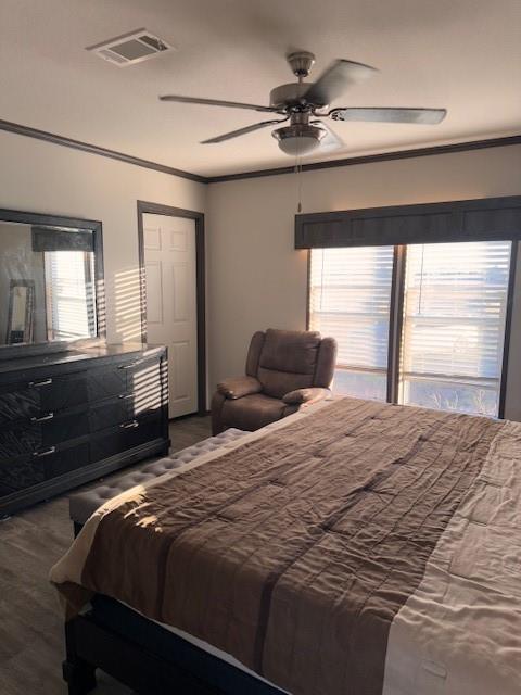6218 Cr-4813 Pecan Gap, TX 75469 - Photo 8 of 30 Bedroom featuring ceiling fan, visible vents, wood finished floors, and crown molding