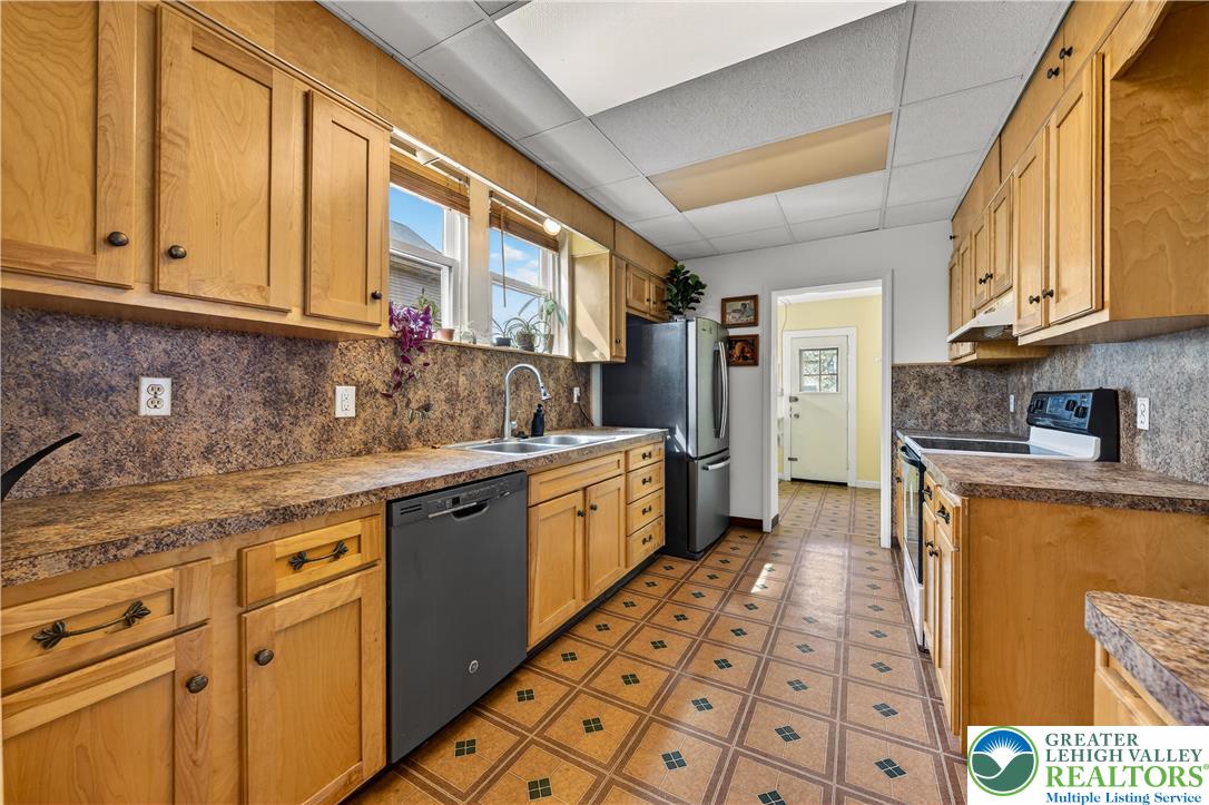 945 Main Street Bethlehem, PA 18018 - Photo 15 of 75 a kitchen with stainless steel appliances granite countertop a sink and cabinets