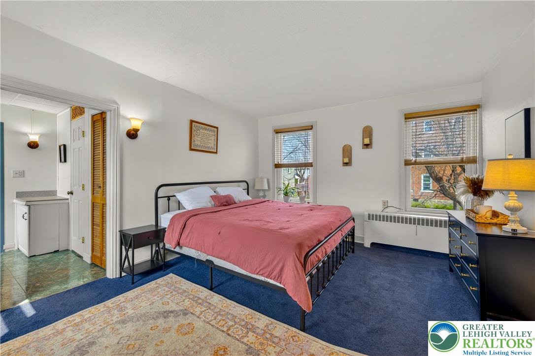 945 Main Street Bethlehem, PA 18018 - Photo 36 of 75 a bedroom with a bed and a dresser with wooden floor