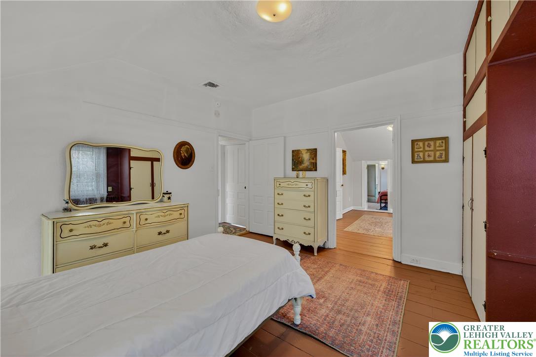 945 Main Street Bethlehem, PA 18018 - Photo 52 of 75 a bedroom with a bed and wooden floor