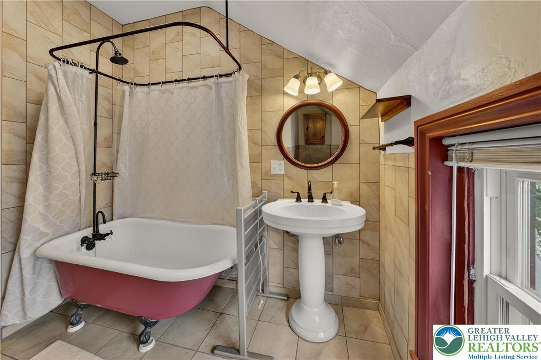 945 Main Street Bethlehem, PA 18018 - Photo 55 of 75 a bathroom with a sink a mirror and a shower