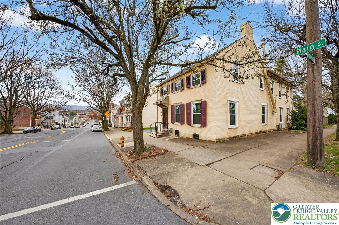 945 Main Street Bethlehem, PA 18018 - Photo 6 of 75 a view of a white house with a large tree
