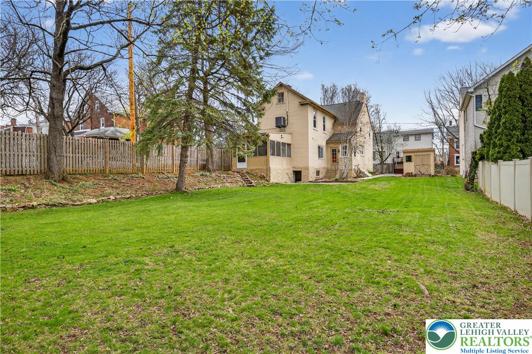 945 Main Street Bethlehem, PA 18018 - Photo 71 of 75 a view of a white house with a big yard and large trees