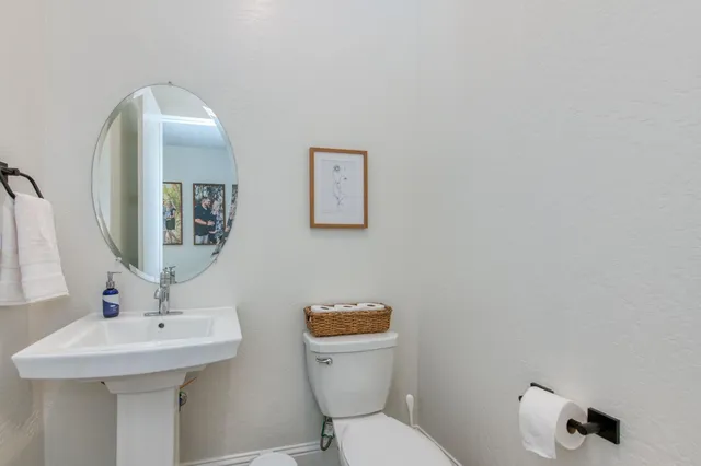 a bedroom with a bed and a lamp on dresser