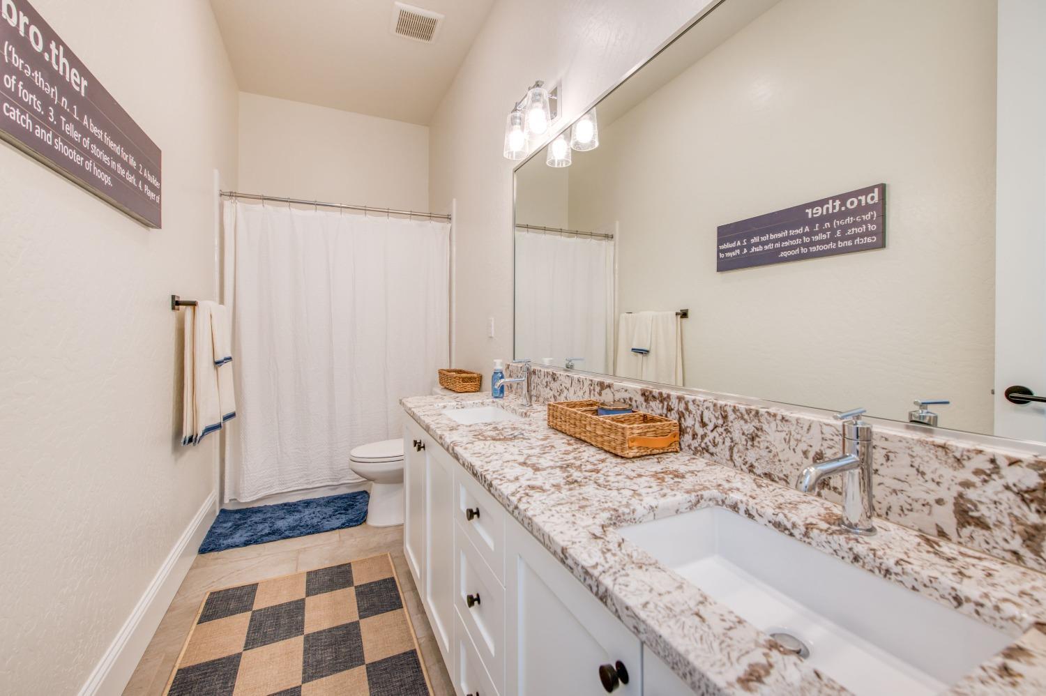 678 Ponderosa Way Madera, CA 93636 - Photo 20 of 38 a bathroom with a sink and a mirror