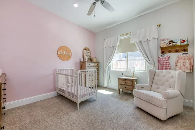 a view of a bedroom with baby bed