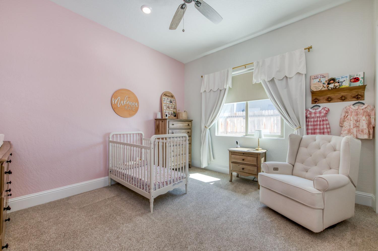 678 Ponderosa Way Madera, CA 93636 - Photo 22 of 38 a living room with furniture a window and a chandelier