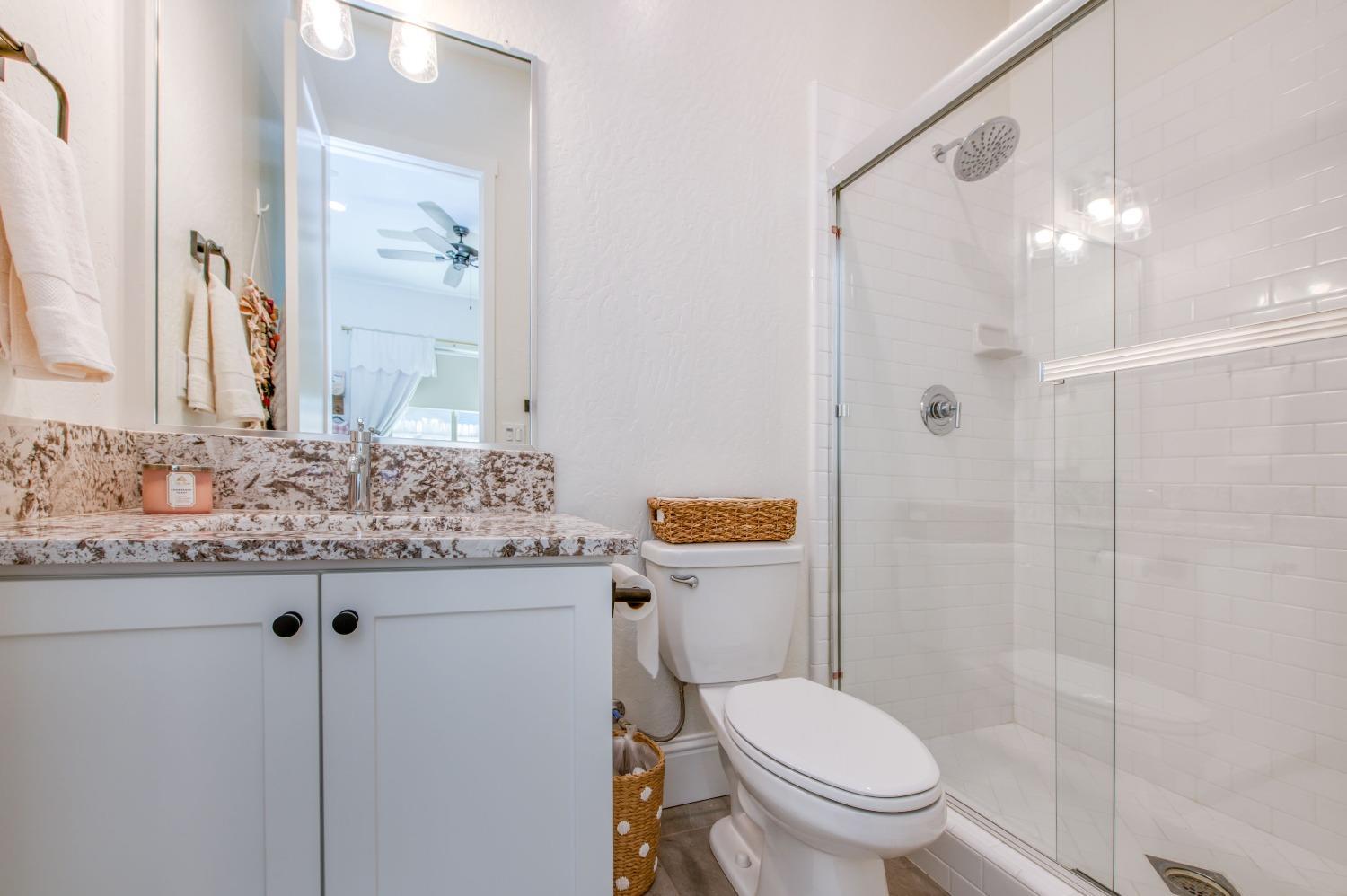 678 Ponderosa Way Madera, CA 93636 - Photo 24 of 38 a bathroom with a granite countertop sink toilet and shower