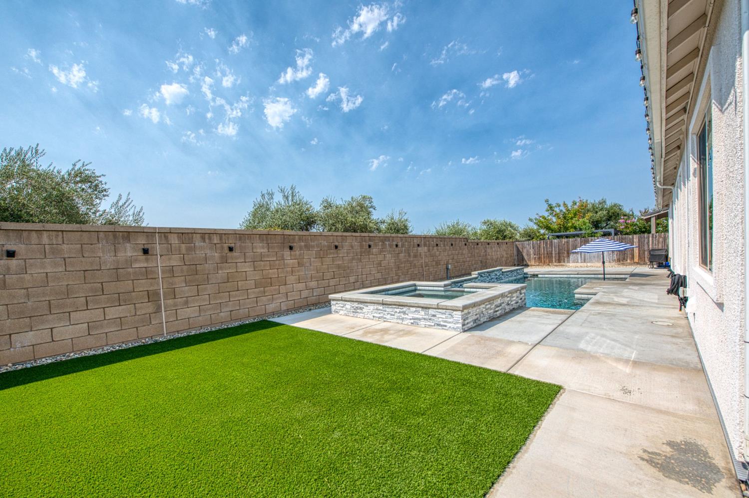 678 Ponderosa Way Madera, CA 93636 - Photo 31 of 38 a view of yard with swimming pool and green space