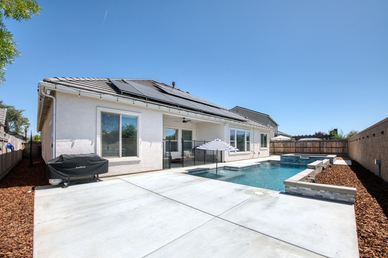 678 Ponderosa Way Madera, CA 93636 - Photo 35 of 38 a front view of a house with a yard and seating space