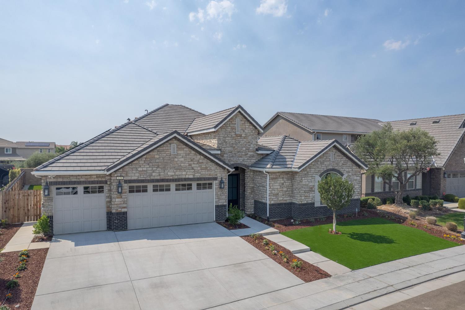 678 Ponderosa Way Madera, CA 93636 - Photo 37 of 38 a front view of a house with a garden and trees