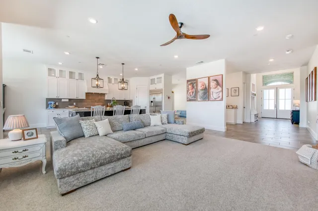 a living room with furniture and kitchen view