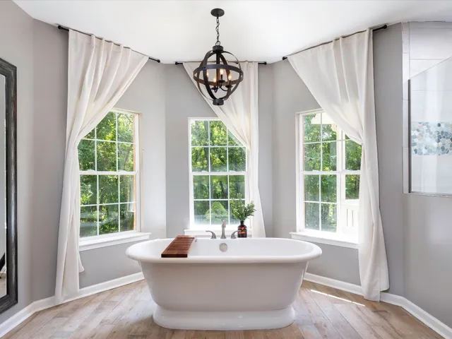 a front view of a house with a yard and potted plants